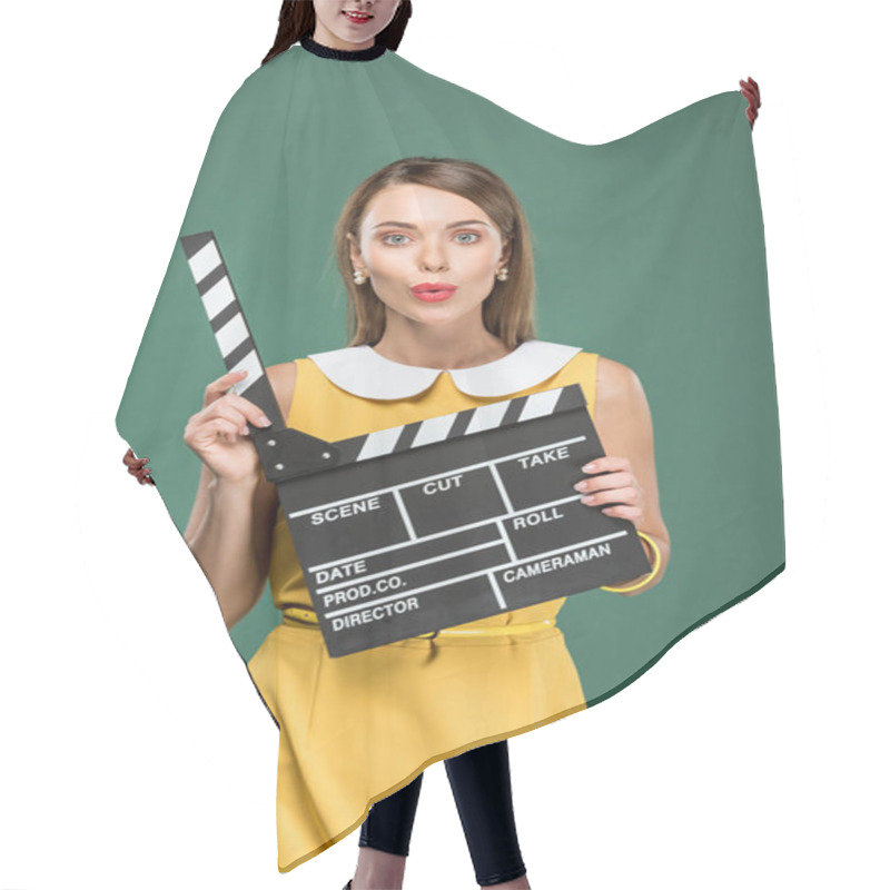 Personality  Beautiful Stylish Woman In Yellow Dress Looking At Camera, Pouting Lips And Holding Film Clapperboard Isolated On Green Hair Cutting Cape