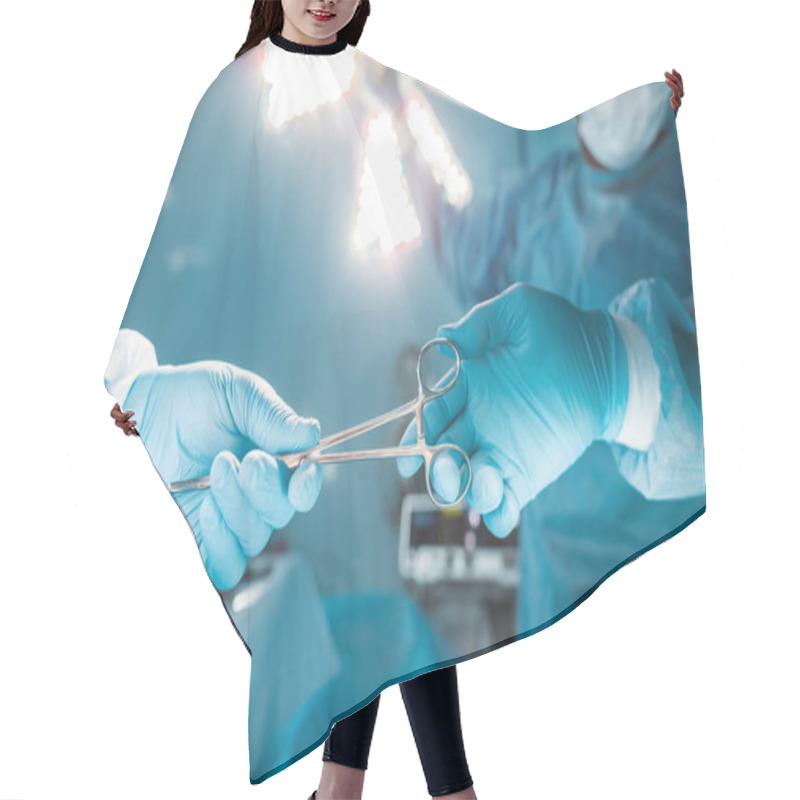 Personality  Cropped Image Of Nurse Passing Medical Scissors To Surgeon  Hair Cutting Cape