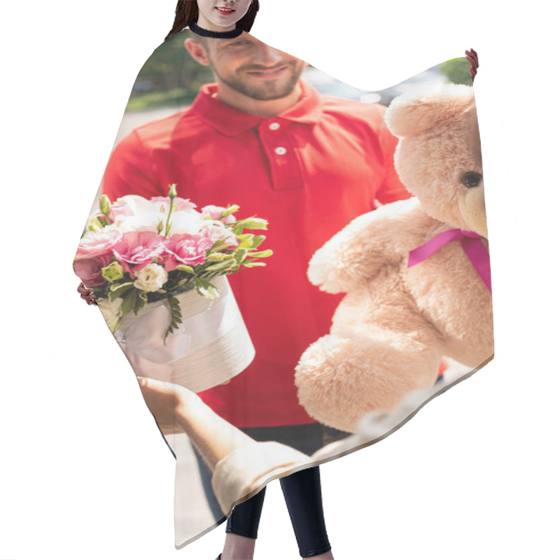 Personality  Selective Focus Of Happy Delivery Man Holding Teddy Bear And Flowers Near Girl Hair Cutting Cape