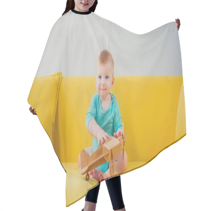 Personality  Happy Infant Boy Sitting On Sofa And Playing With Wooden Biplane Hair Cutting Cape