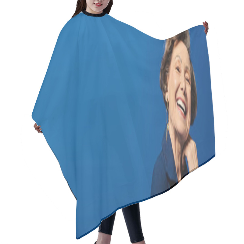 Personality  A Stylish Woman In Her 60s Poses Gracefully Against A Blue Background, Banner Hair Cutting Cape