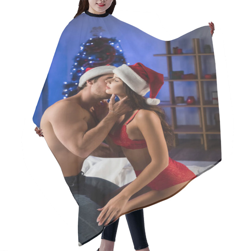 Personality  Sexy Couple In Santa Hats Kissing On Bed Near Blurred Christmas Tree On Background Hair Cutting Cape