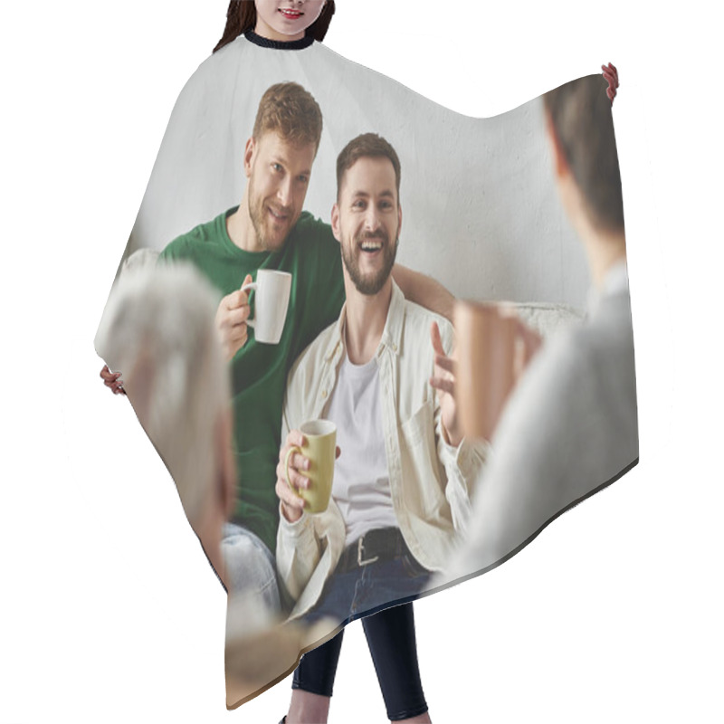 Personality  A Gay Couple Sits On A Couch With Parents, Enjoying Coffee And Conversation. Hair Cutting Cape