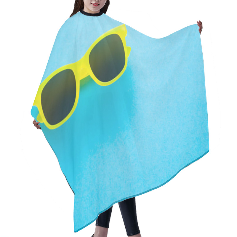 Personality  Top View Of Sunglasses On Blue Background  Hair Cutting Cape