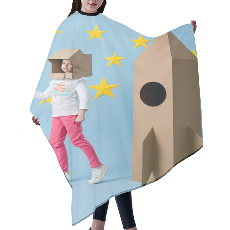 Personality  Funny Kid In Helmet Standing Near Cardboard Rocket On Blue Background With Stars Hair Cutting Cape