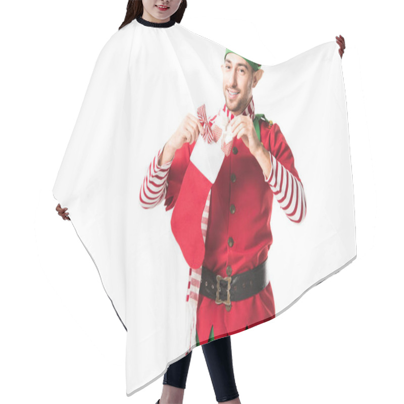 Personality  Smiling Man In Christmas Elf Costume Putting Present In Red Christmas Stocking And Looking At Camera Isolated On White Hair Cutting Cape