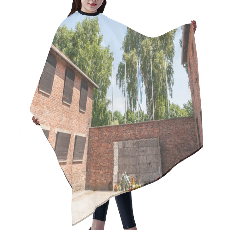 Personality  Memorial At Auschwitz Between Buildings With Flowers Hair Cutting Cape