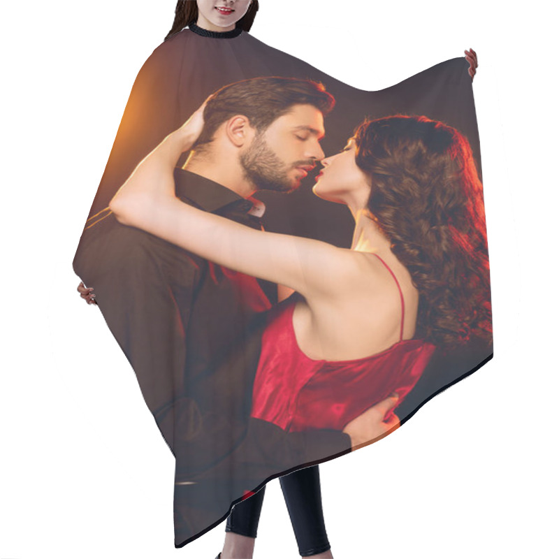 Personality  Side View Of Elegant Woman In Red Dress Embracing And Kissing Handsome Boyfriend On Black Background With Lighting Hair Cutting Cape