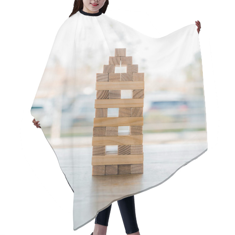 Personality  KYIV, UKRAINE - NOVEMBER 22, 2019:  Blocks Wood Tower Game On Wooden Desk  Hair Cutting Cape