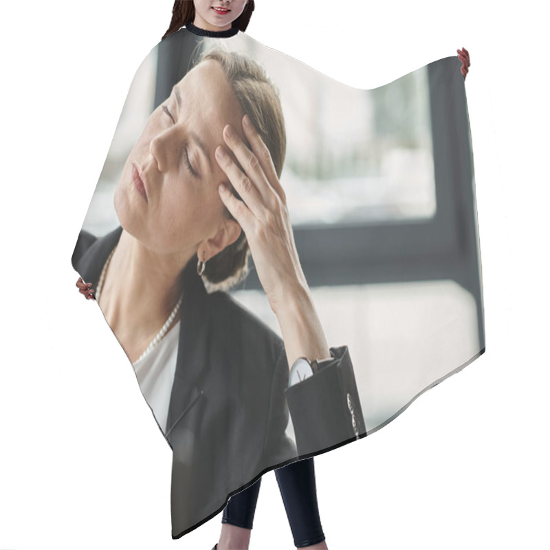 Personality  Middle Aged Woman In Business Suit Holds Head While Working On Laptop. Hair Cutting Cape