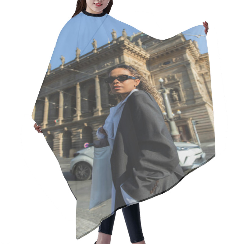 Personality  Low Angle View Of Young African American Woman In Stylish Blazer And Sunglasses Near National Theatre In Prague Hair Cutting Cape