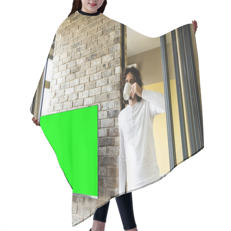 Personality  Young Man In Pajamas Drinking Coffee While Standing Near Green Lcd Screen Hanging On Brick Wall Hair Cutting Cape