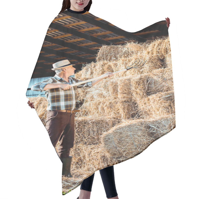 Personality  Senior Farmer In Straw Hat Holding Rake Near Hay  Hair Cutting Cape