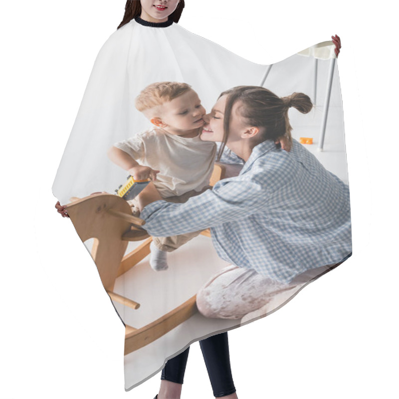 Personality  Happy Woman Hugging Son Sitting On Rocking Horse On White Hair Cutting Cape