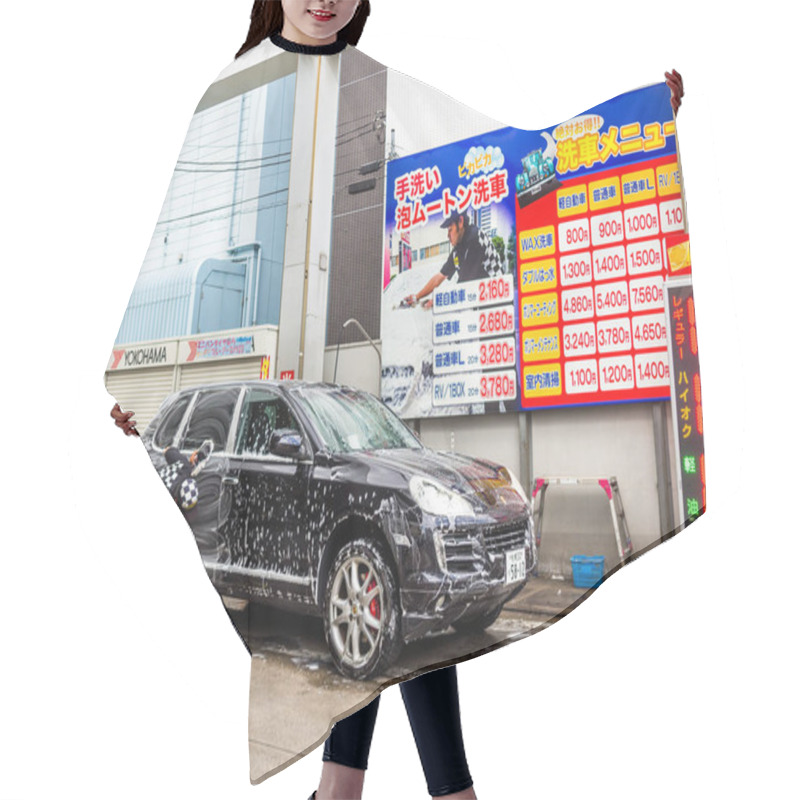 Personality  YUFUIN, JAPAN JUNE 28 - 2017: Close View Of A Car Wash With A Man Cleaning A Black Car At Station Yufuin Village Where Is The Destination Of Tourist For Looking The Local Village In Japanese Style Hair Cutting Cape