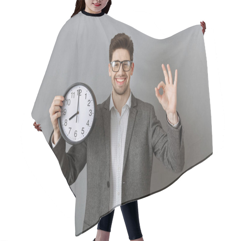 Personality  Portrait Of Smiling Businessman With Clock In Hand Showing Ok Sign On Grey Wall Background Hair Cutting Cape