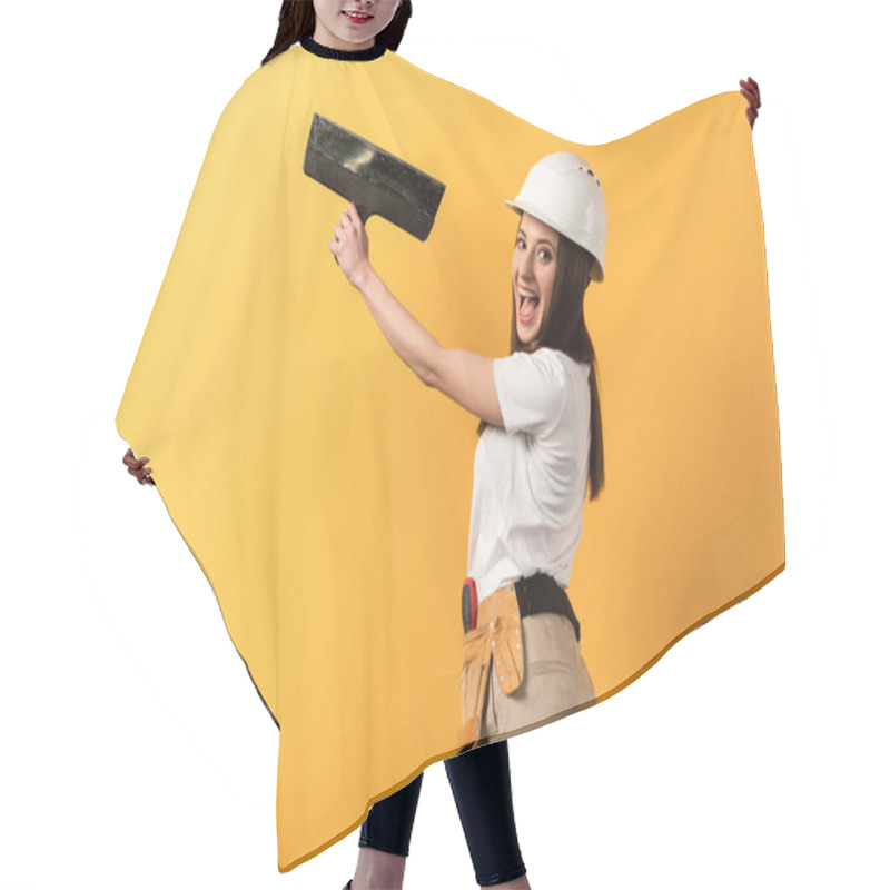 Personality  Smiling Handywoman In Helmet Holding Trowel On Yellow Background  Hair Cutting Cape