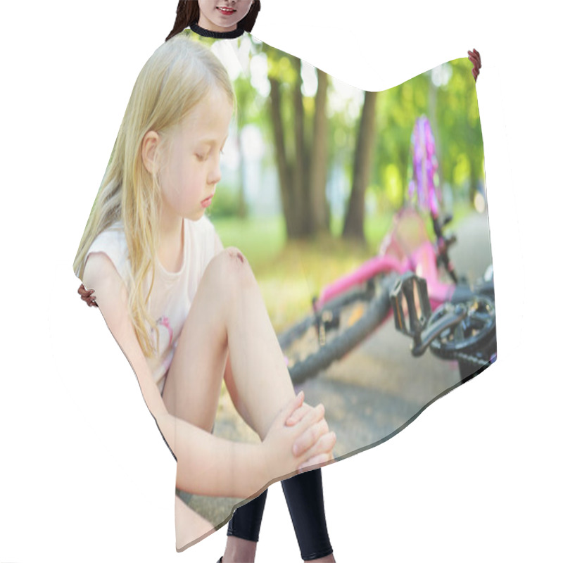 Personality  Cute Little Girl Sitting On The Ground After Falling Off Her Bike At Summer Park. Child Getting Hurt While Riding A Bicycle. Active Family Leisure With Kids. Hair Cutting Cape