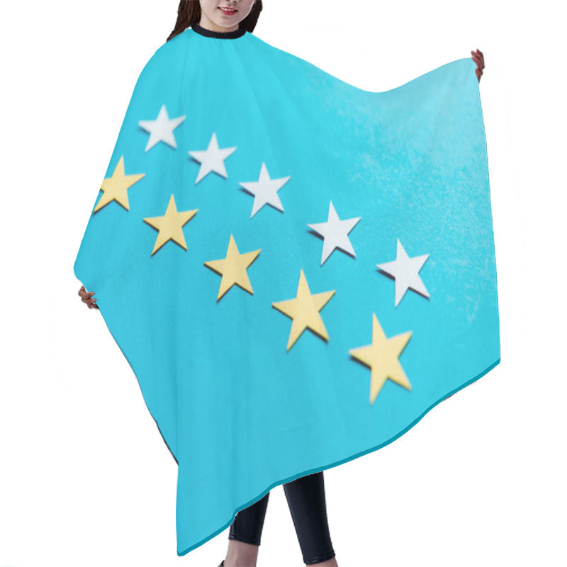 Personality  Selective Focus Of White And Yellow Stars On Blue  Hair Cutting Cape