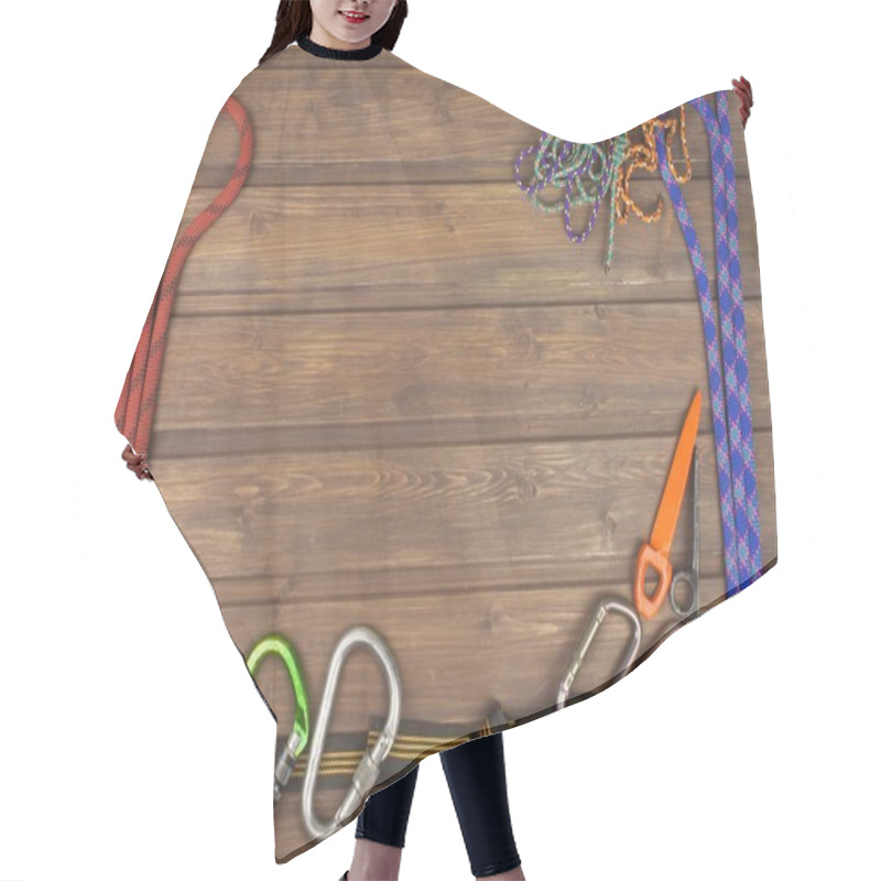 Personality  Used Climbing Gear On Wooden Background. Advertising Boards Of Trade. The Concept Of Extreme Sports. Decoration Of Older Equipment Climbers. Hair Cutting Cape