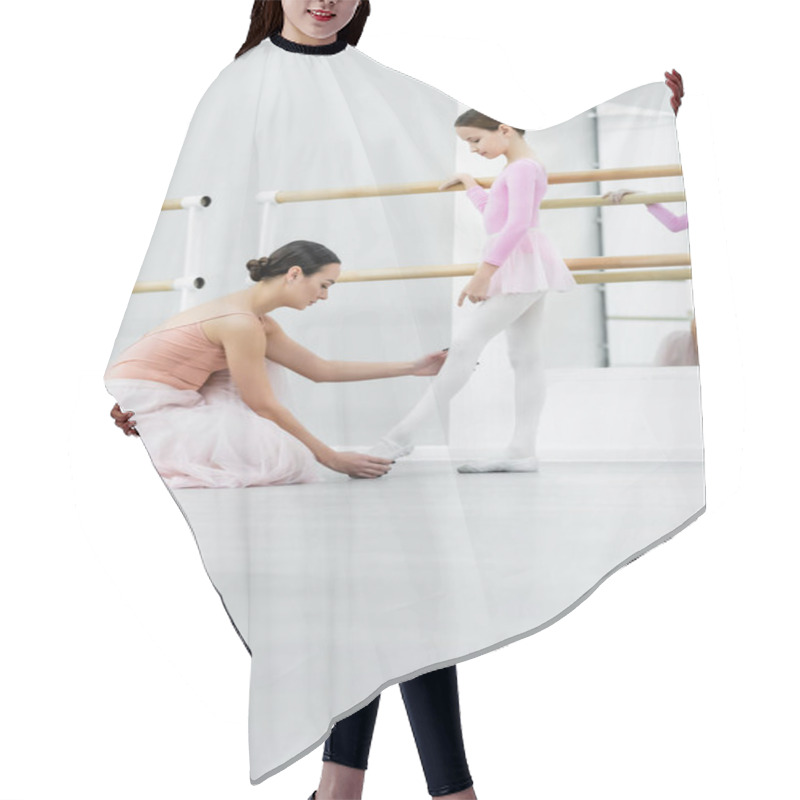 Personality  Side View Of Dance Teacher Touching Leg Of Girl Training In Ballet School Hair Cutting Cape