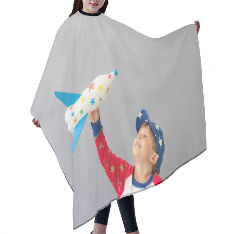 Personality  Happy Child Playing With Toy Rocket Against Concrete Wall Background. Kid Pretend To Be Astronaut. Imagination And Children Dream Concept Hair Cutting Cape