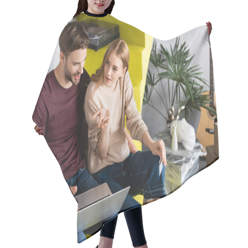 Personality  High Angle View Of Woman Pointing With Hand While Holding Credit Card Near Boyfriend Using Laptop  Hair Cutting Cape