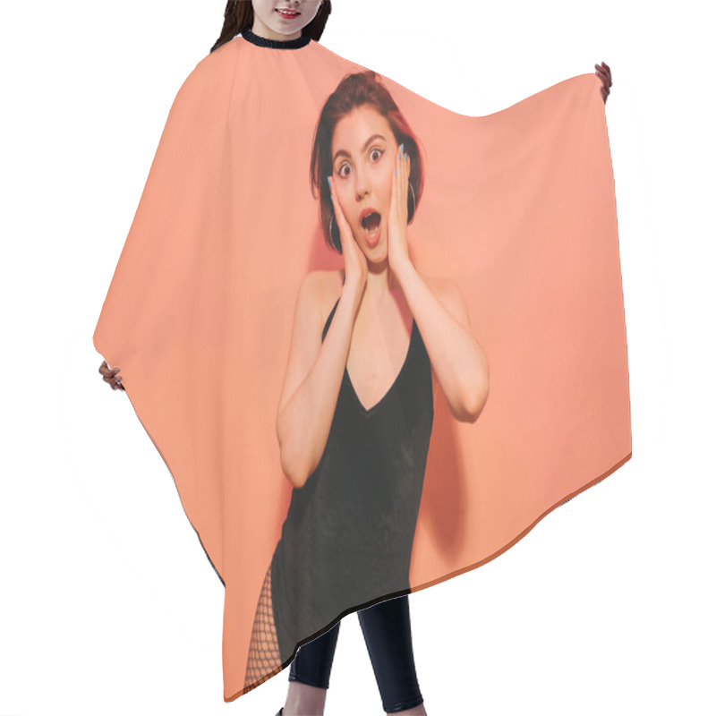 Personality  Excited Young Woman Grimacing With Hands Near Face On Orange Background Hair Cutting Cape