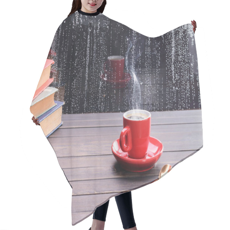 Personality  Red Coffee Cup With Hot Black Coffee With Hot Steam Set On An Old Vintage Wooden Table With Stacks Of Books By The Window On A Rainy Day With Raindrops On The Glass Floor. Hair Cutting Cape