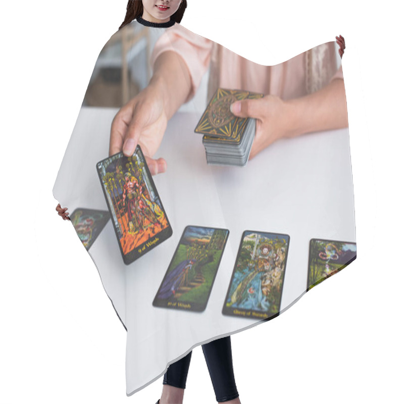 Personality  KYIV, UKRAINE - JUNE 29, 2022: Partial View Of Woman Predicting On Tarot Cards At Home Hair Cutting Cape