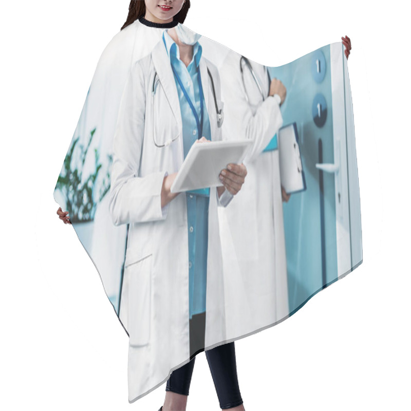 Personality  Partial View Of Female Doctor In Medical Mask Using Digital Tablet While Her Male Colleague Standing Behind With Clipboard In Hospital Corridor  Hair Cutting Cape