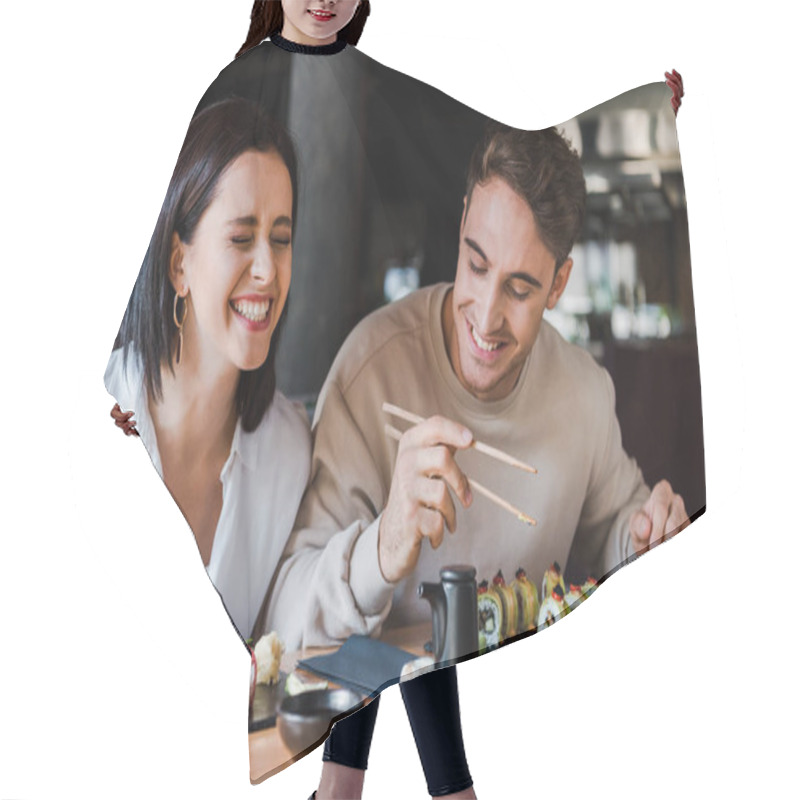 Personality  Happy Man And Cheerful Woman Laughing While Holding Chopsticks With Tasty Sushi In Restaurant  Hair Cutting Cape