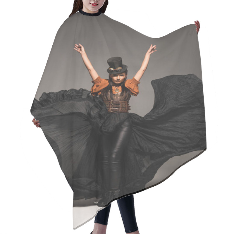 Personality  Full Length View Of Attractive Steampunk Woman In Top Hat With Goggles Standing With Hands Up On Grey Hair Cutting Cape