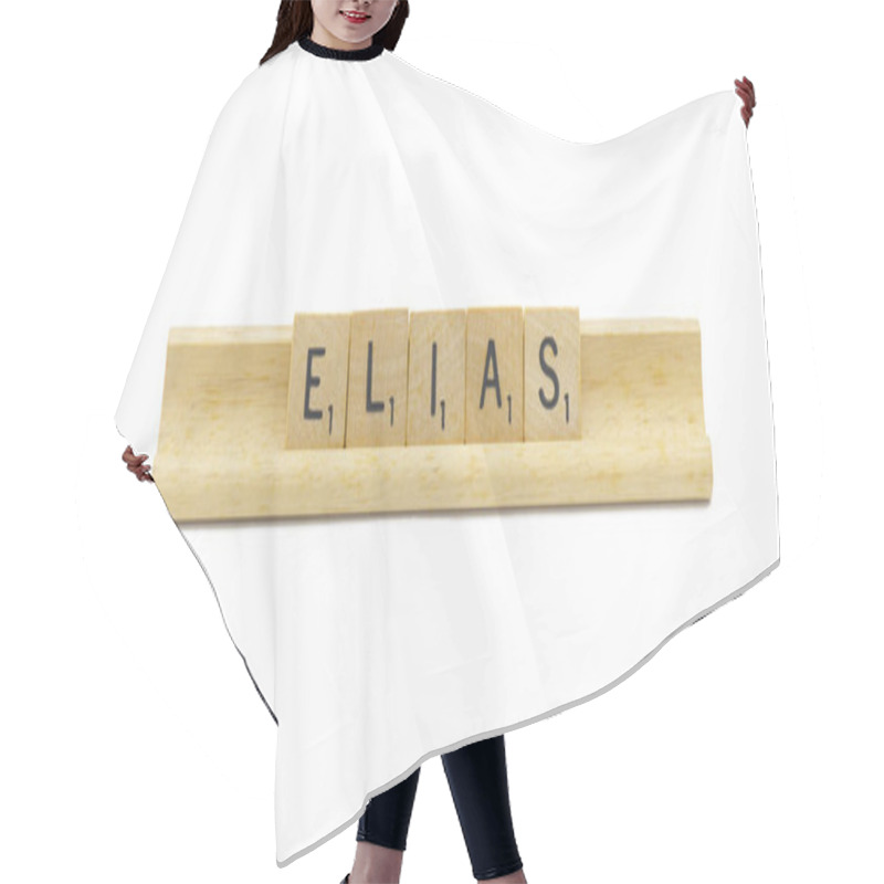 Personality  Miami, FL 4-18-24 Popular Baby Boy First Name Of ELIAS Made With Square Wooden Tile English Alphabet Letters With Natural Color And Grain On A Wood Rack Holder Isolated On White Background Hair Cutting Cape