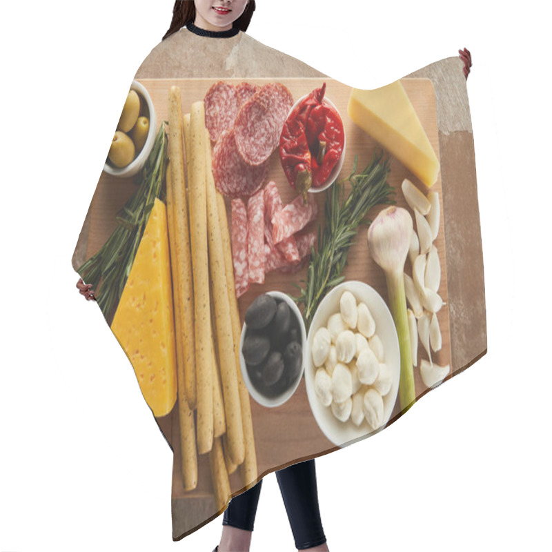 Personality  Top View Of Board With Breadsticks, Cheese, Salami Slices And Antipasto Ingredients On Brown Hair Cutting Cape