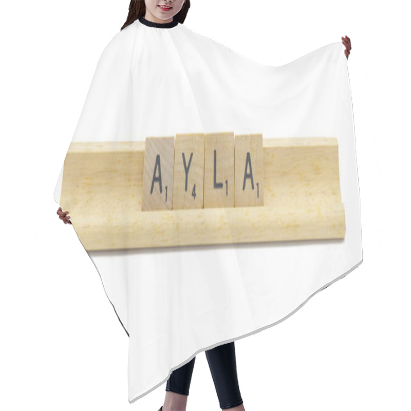 Personality  Miami, FL 4-18-24 Popular Baby Girl First Name Of AYLA Made With Square Wooden Tile English Alphabet Letters With Natural Color And Grain On A Wood Rack Holder Isolated On White Background Hair Cutting Cape