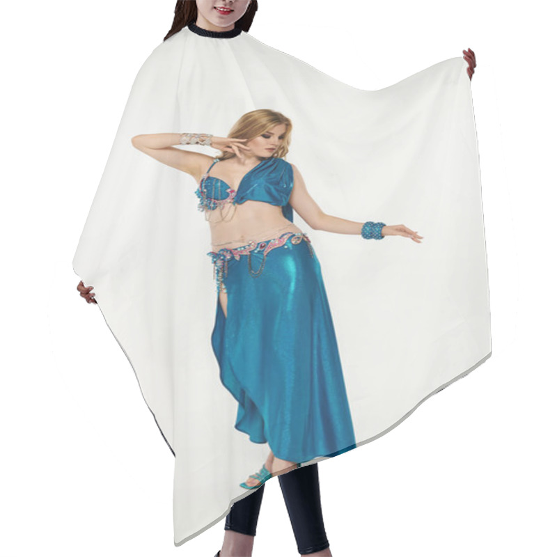 Personality  A Graceful Woman In A Mesmerizing Blue Costume Showcases Her Belly Dance Skills. Hair Cutting Cape