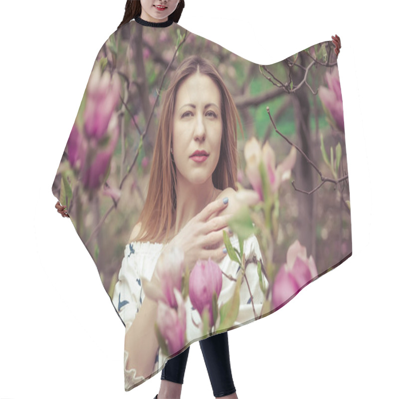 Personality  Young Beautiful Caucasian Woman In Blooming Spring Garden Of Magnolias . The Girl In The Garden On A Cloudy Day . Hair Cutting Cape