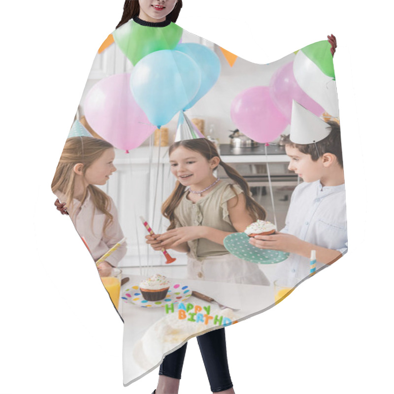 Personality  Preteen Boy In Party Cap Holding Cupcake Near Cheerful Girls Next To Balloons During Birthday Party  Hair Cutting Cape