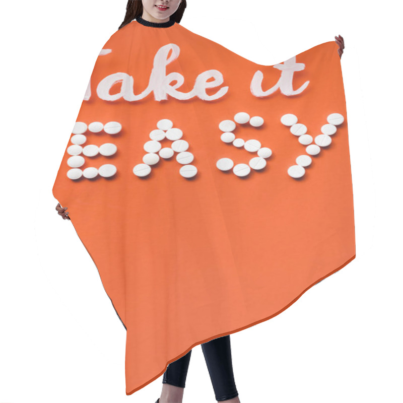 Personality  Top View Of Lettering Take It Easy Made By White Pills On Red Background  Hair Cutting Cape