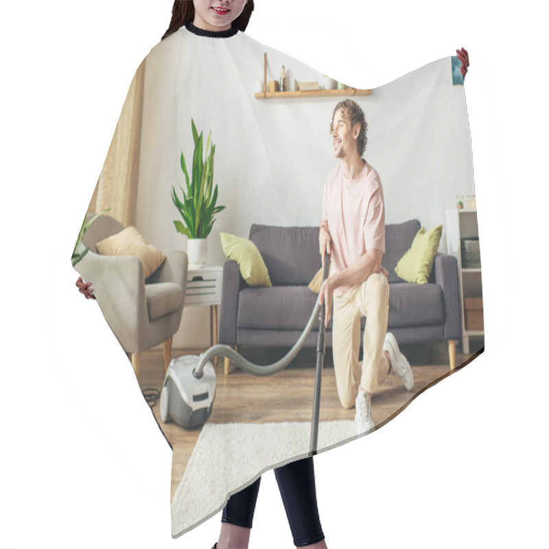 Personality  A Man In Cozy Homewear Diligently Vacuums A Living Room. Hair Cutting Cape