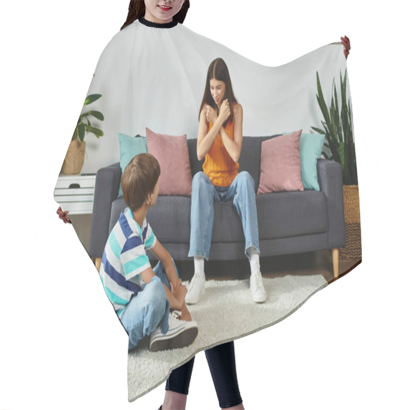 Personality  A Mother Engages With Her Son Who Has A Hearing Impairment While Sitting In Their Warm Living Room. Hair Cutting Cape