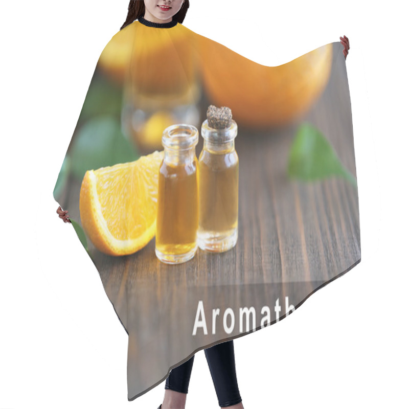 Personality  Spa Composition With Essence And Slice Of Orange, Closeup. Word AROMATHERAPY On Background. Spa Beauty Concept. Hair Cutting Cape