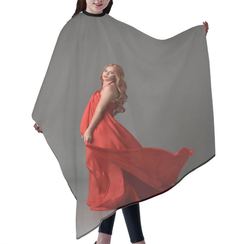 Personality  Full Length Portrait Of Woman Wearing A Red Silk Dress, Standing Pose On Grey Studio Background. Hair Cutting Cape