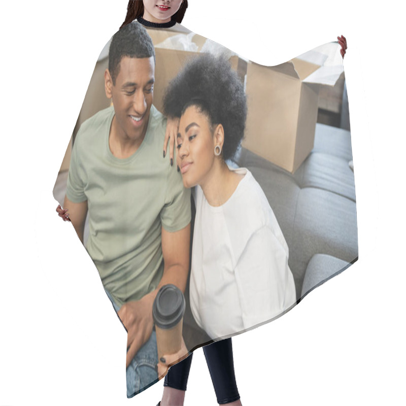 Personality  Pleased African American Woman Holding Coffee To Go Near Boyfriend And Packages In New Home Hair Cutting Cape