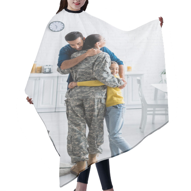 Personality  Husband And Daughter Hugging Mother In Military Uniform Near Backpack At Home  Hair Cutting Cape