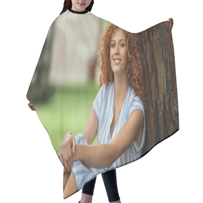 Personality  Positive Redhead Woman In Blue Striped Dress Sitting Under Tree Trunk Hair Cutting Cape