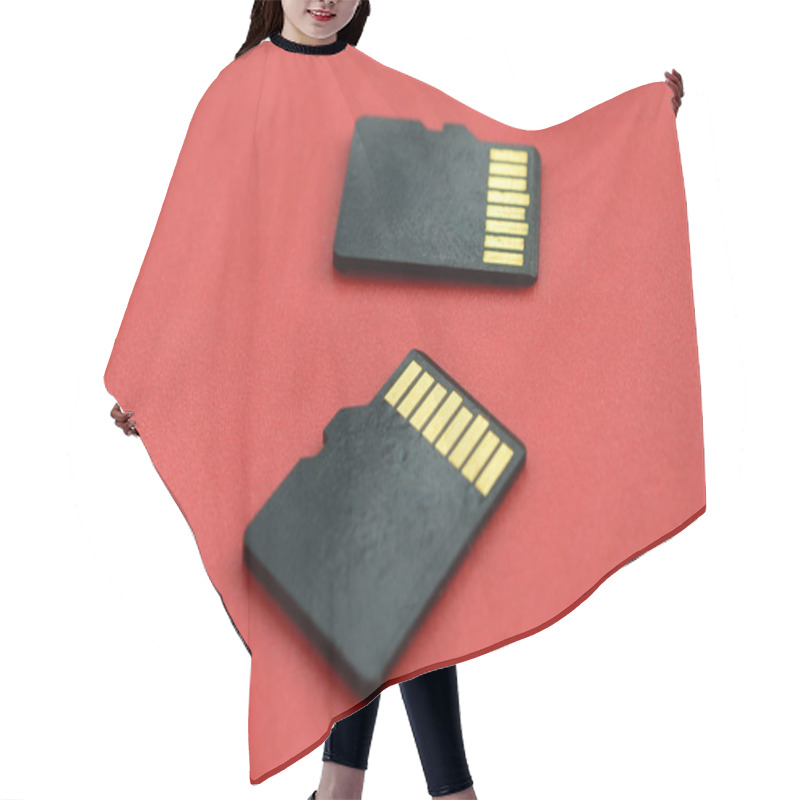 Personality  Two Small Micro SD Memory Cards Lie On A Red Background. A Small And Compact Data And Information Store Hair Cutting Cape