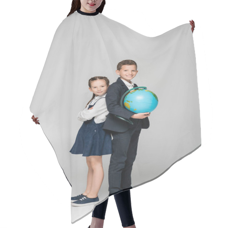 Personality  Happy Schoolboy Holding Globe While Standing With Girl In Dress On Grey Hair Cutting Cape