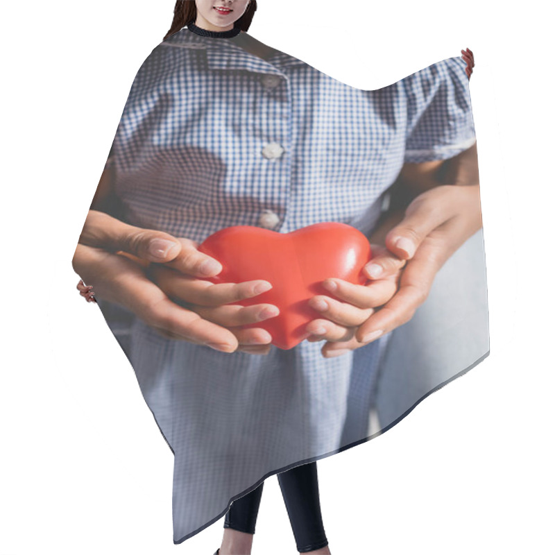 Personality  African American Girl With Mother Holding Heart Model In Cupped Hands Hair Cutting Cape